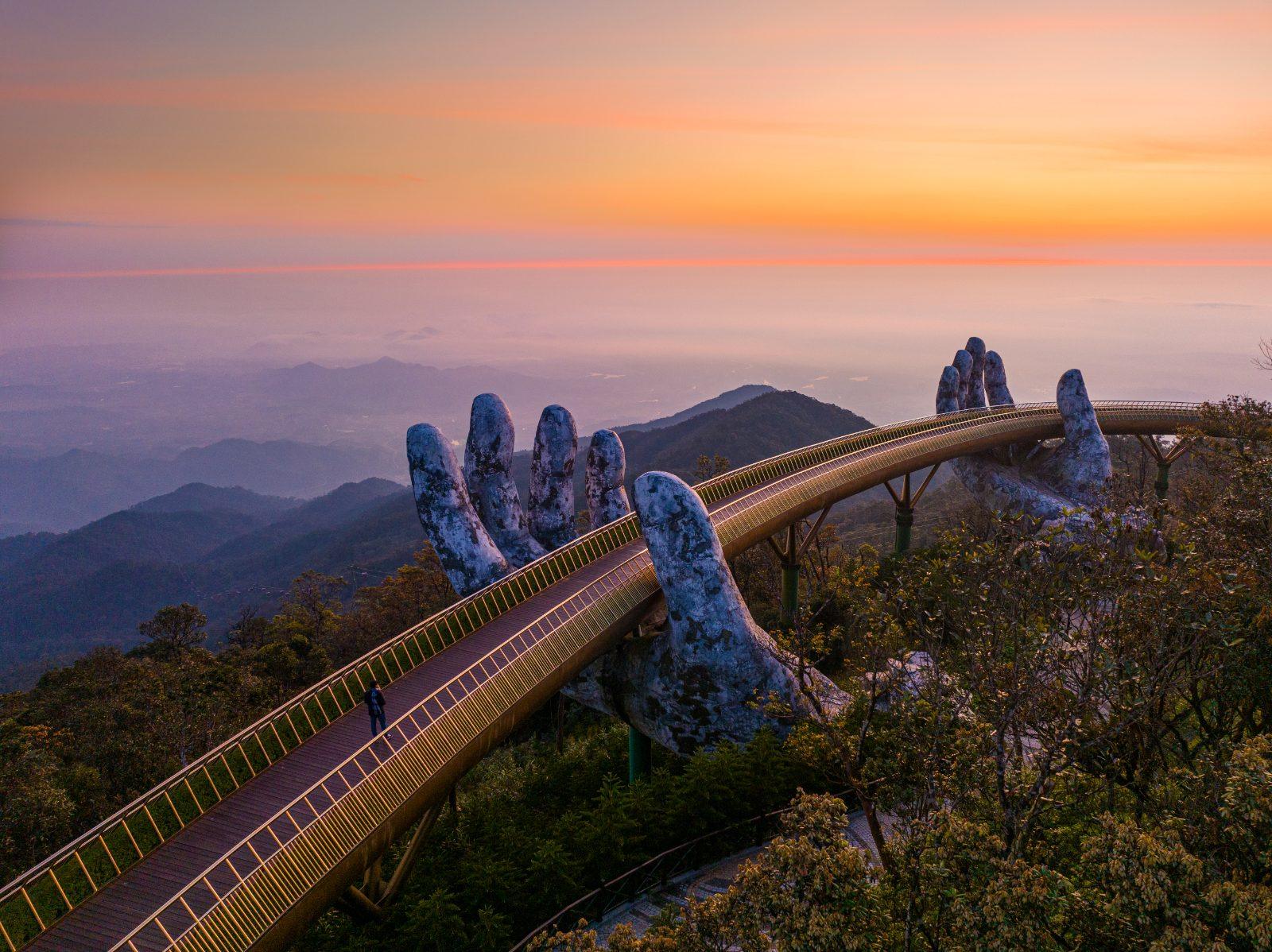 The Golden Bridge held up by giant stone hands at Ba Na Hills near Da Nang