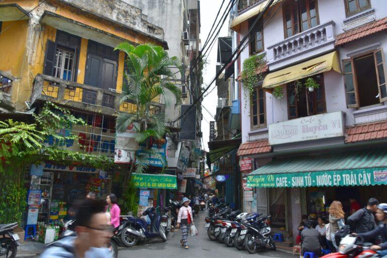 A street in the Hanoi Old Quarter lined with motorbikes and shopfronts