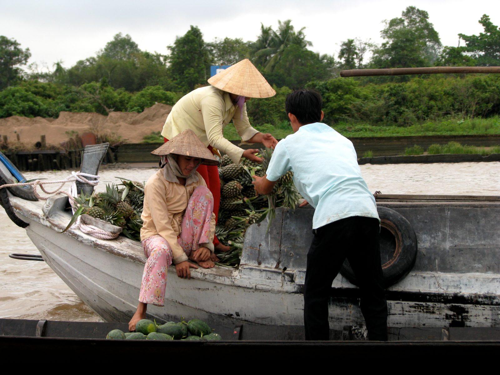 Boats loaded with produce at the Cai Be floating market in the Mekong Delta