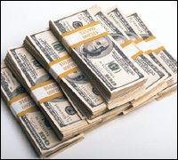 Stacks of cash representing a travel budget