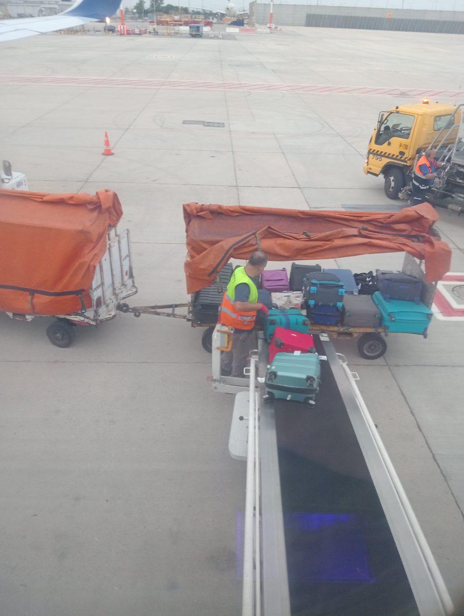 Luggage cart loaded with travel bags