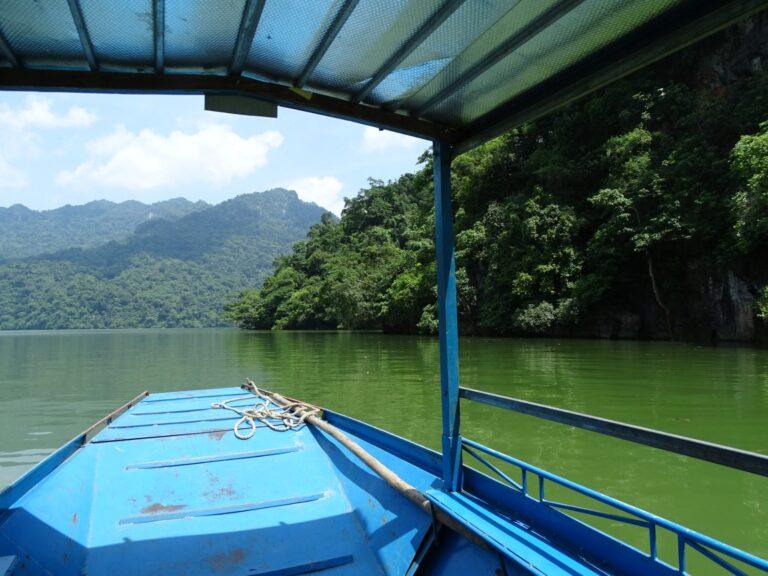 View from a traditional boat touring Ba Be Lake between limestone cliffs