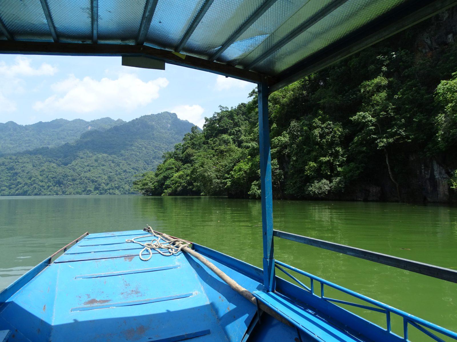 View from a traditional boat touring Ba Be Lake between limestone cliffs