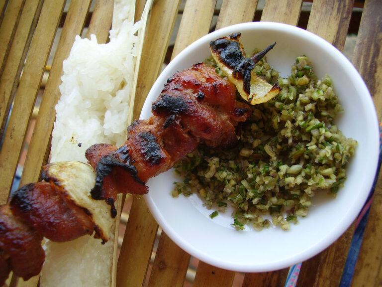 Com lam bamboo-tube sticky rice served with a grilled meat skewer, a Northern Vietnam highland specialty