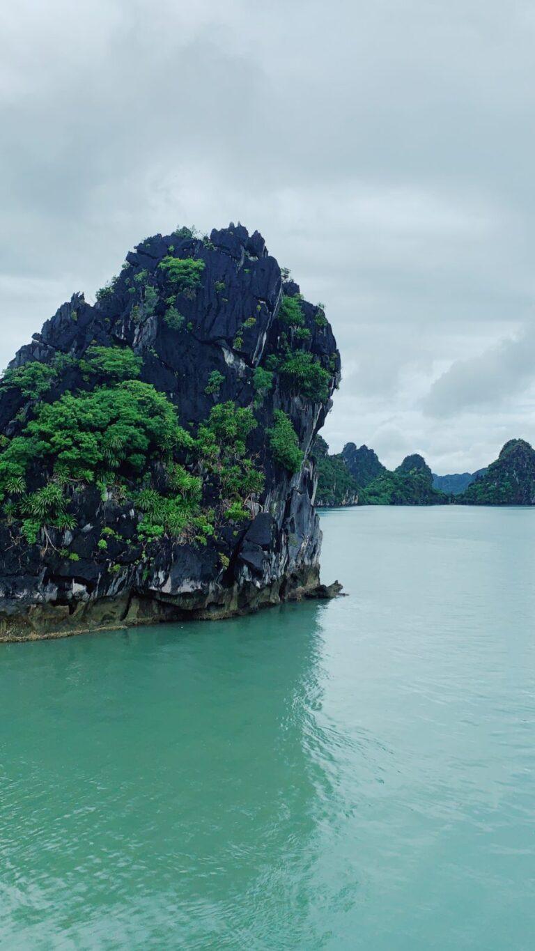 Limestone karst islands rising from the water in Ha Long Bay, Vietnam