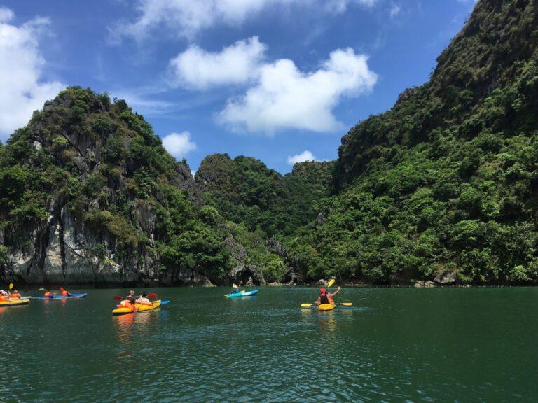 Tourists kayaking among the limestone karsts of Ha Long Bay