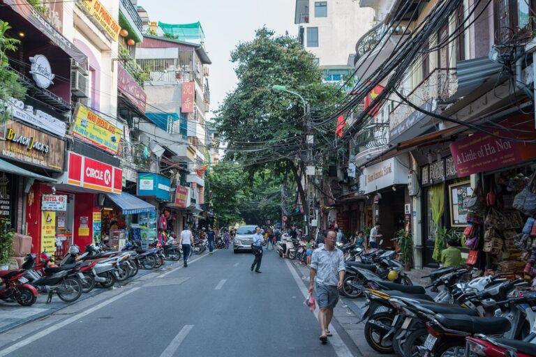 Busy Hanoi Old Quarter street with motorbikes and shops