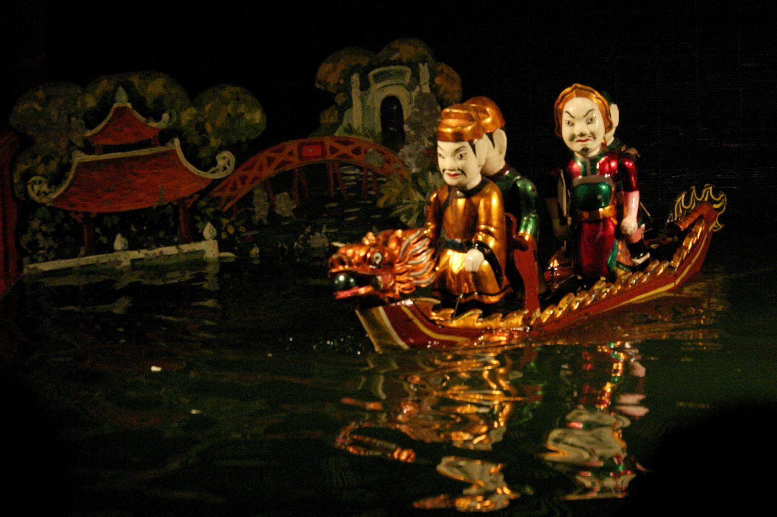 Vietnamese water puppets acting out the Legend of the Restored Sword, King Le Loi on a boat