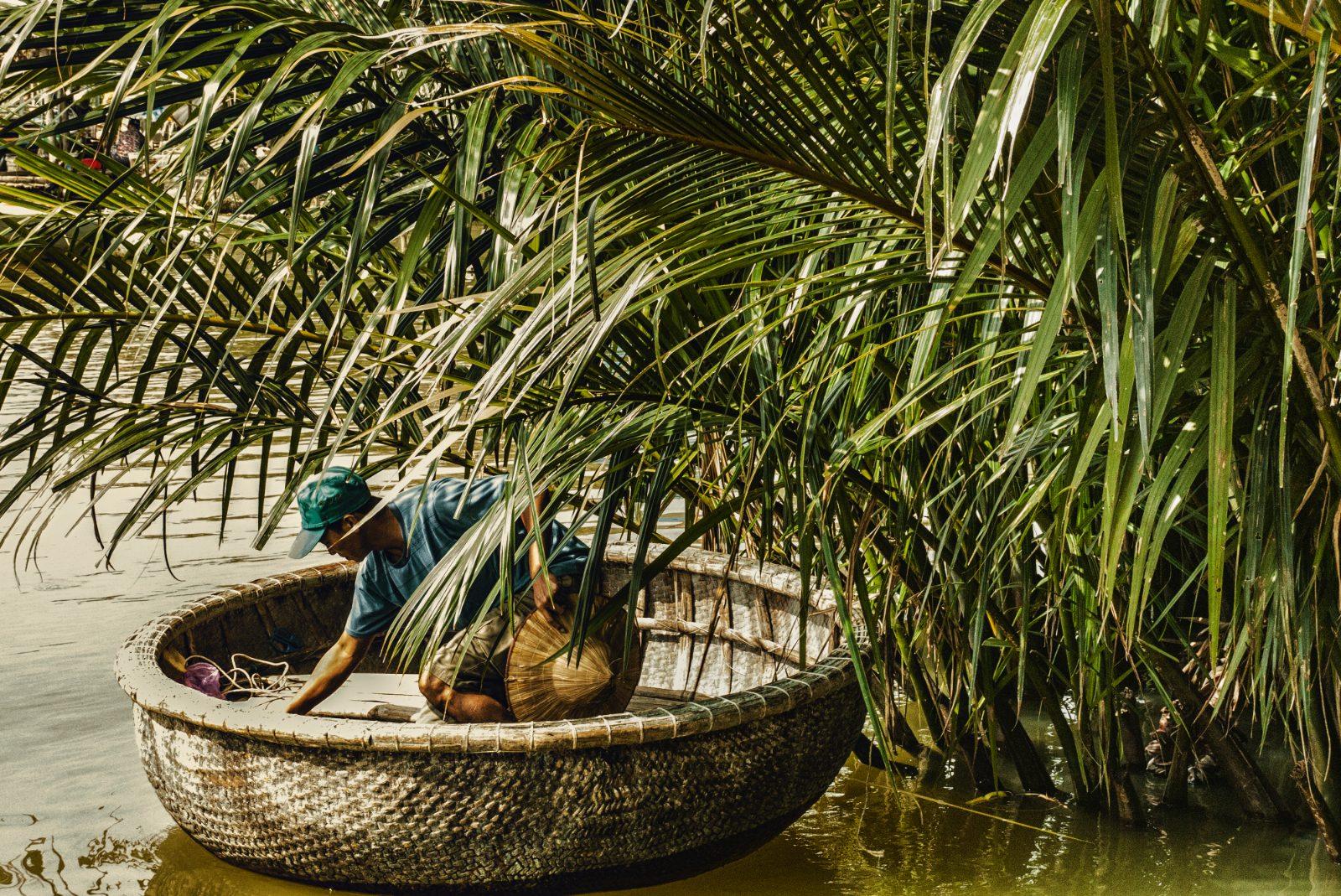 A traditional round basket boat on the water at Cam Thanh Coconut Village near Hoi An