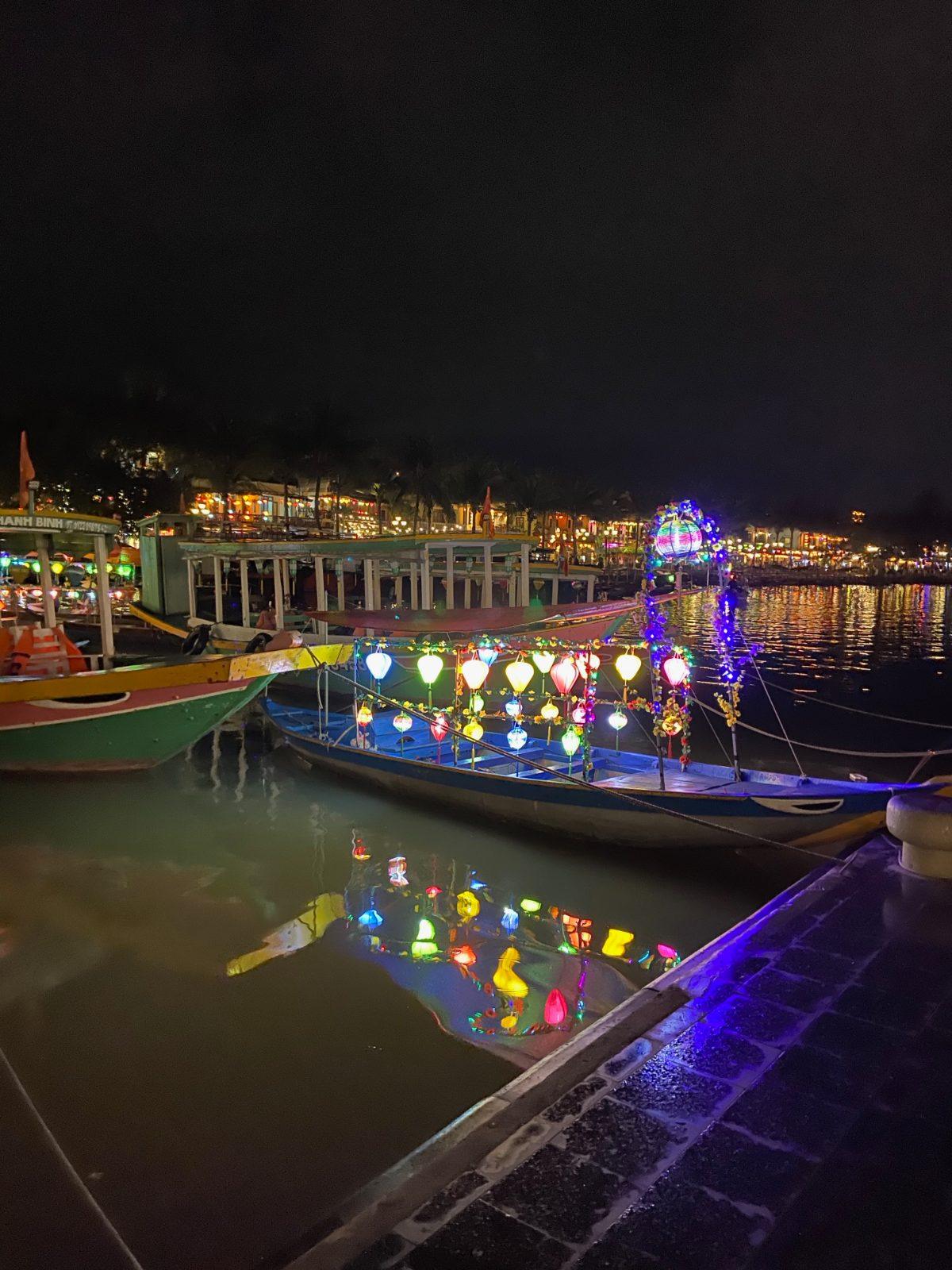Boats carrying colorful lanterns on the Thu Bon River in Hoi An at night