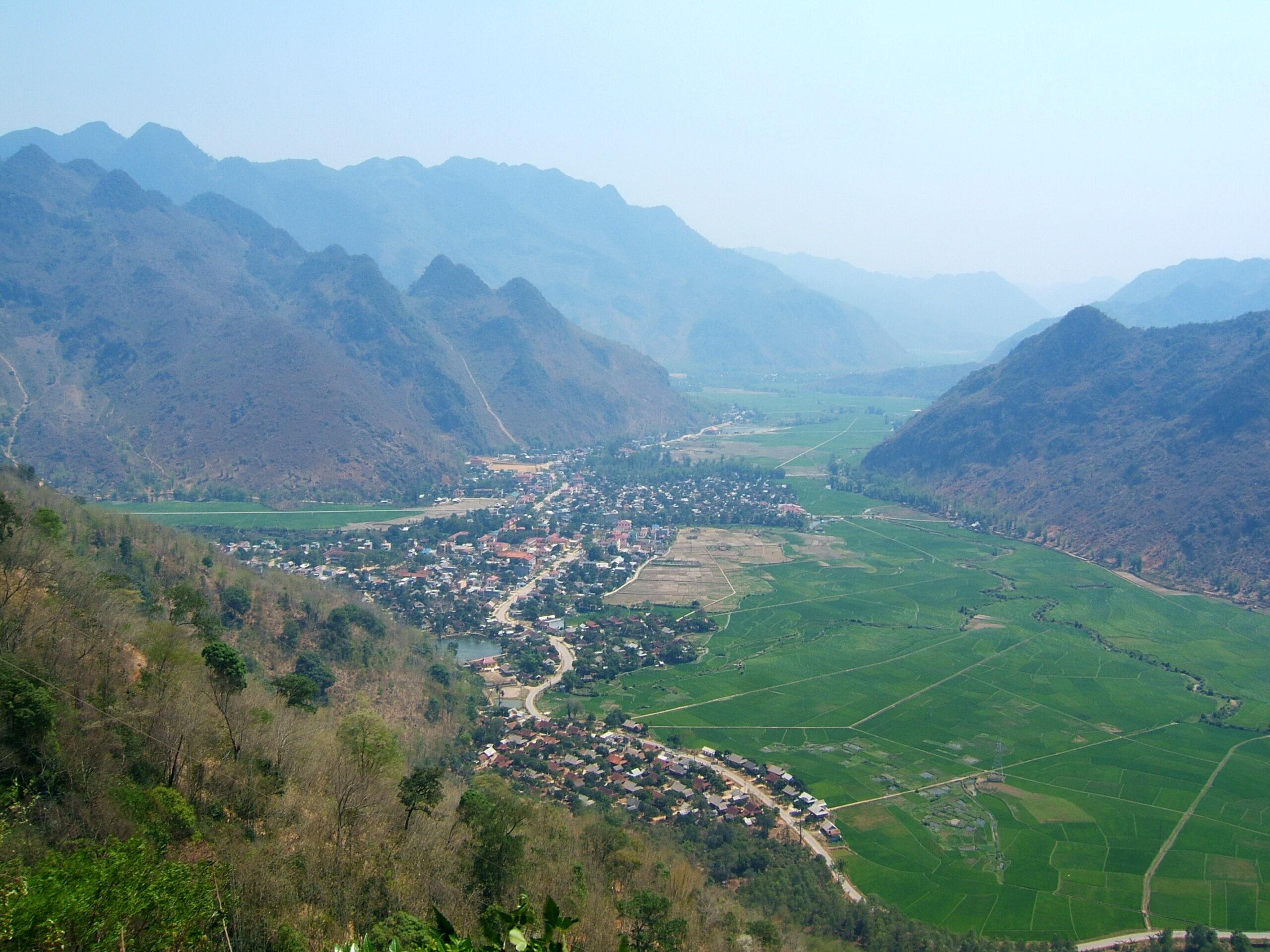 Aerial view of Mai Chau valley and rice fields surrounded by limestone mountains