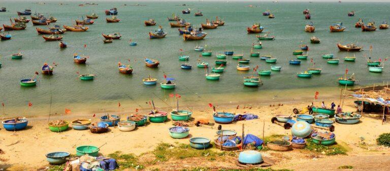 Traditional fishing boats in Mui Ne fishing village harbor