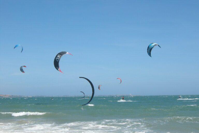 A kiteboarder catching air off Mui Ne beach, Vietnam