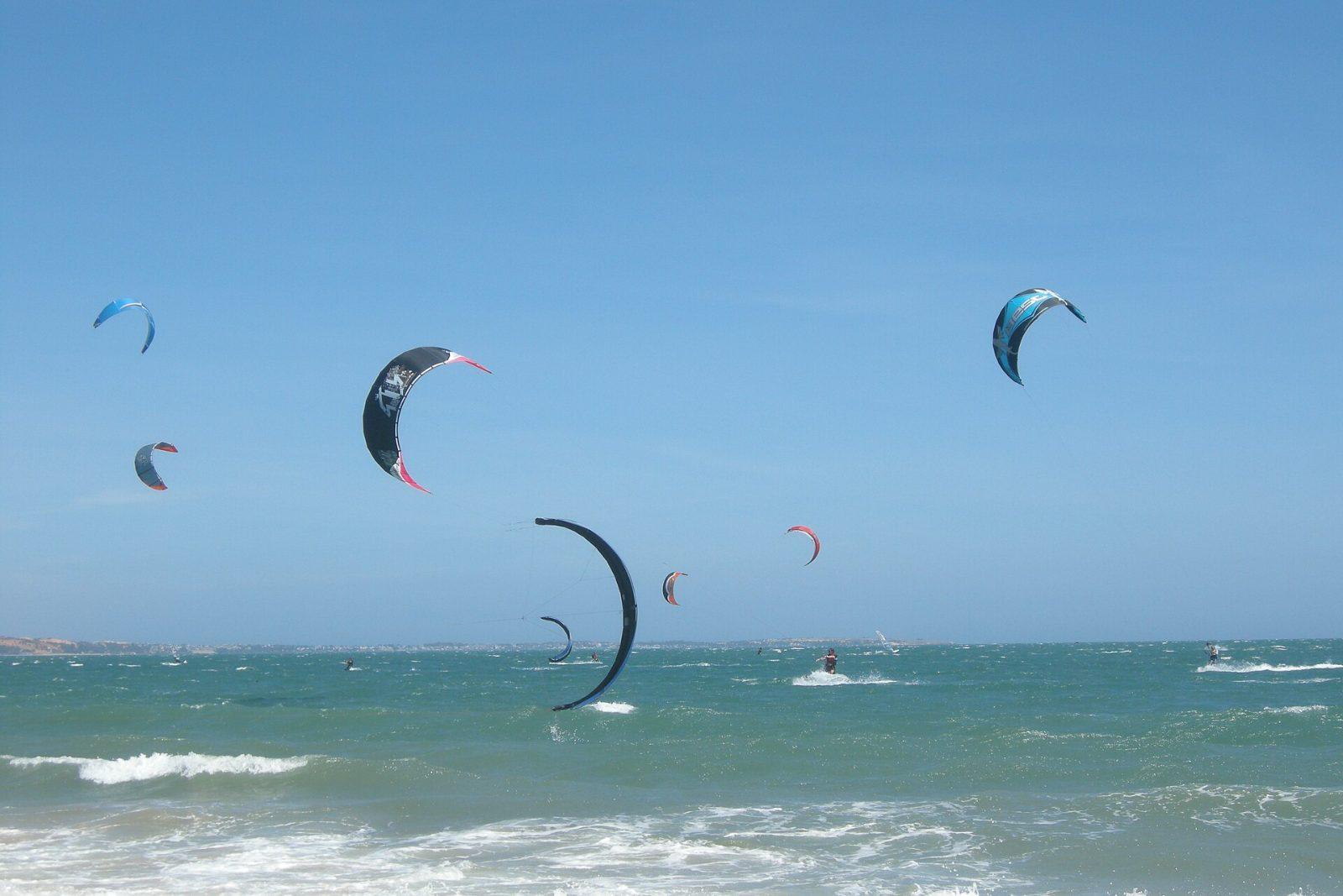 A kiteboarder catching air off Mui Ne beach, Vietnam