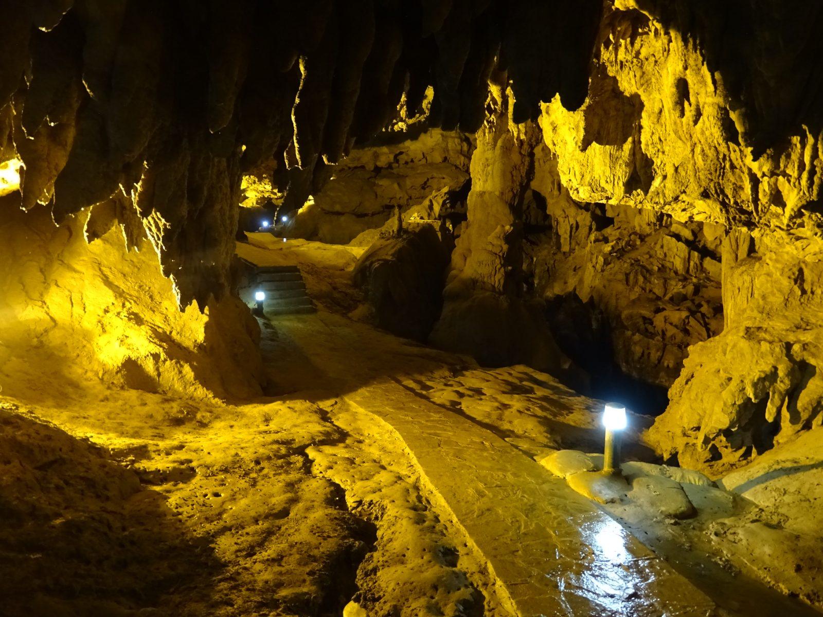 Illuminated limestone formations inside Nguom Ngao Cave