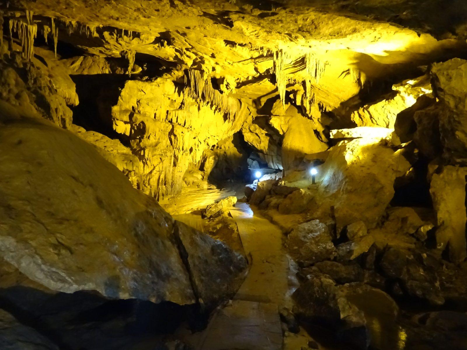 A lit walkway through the stalactite chambers of Nguom Ngao Cave