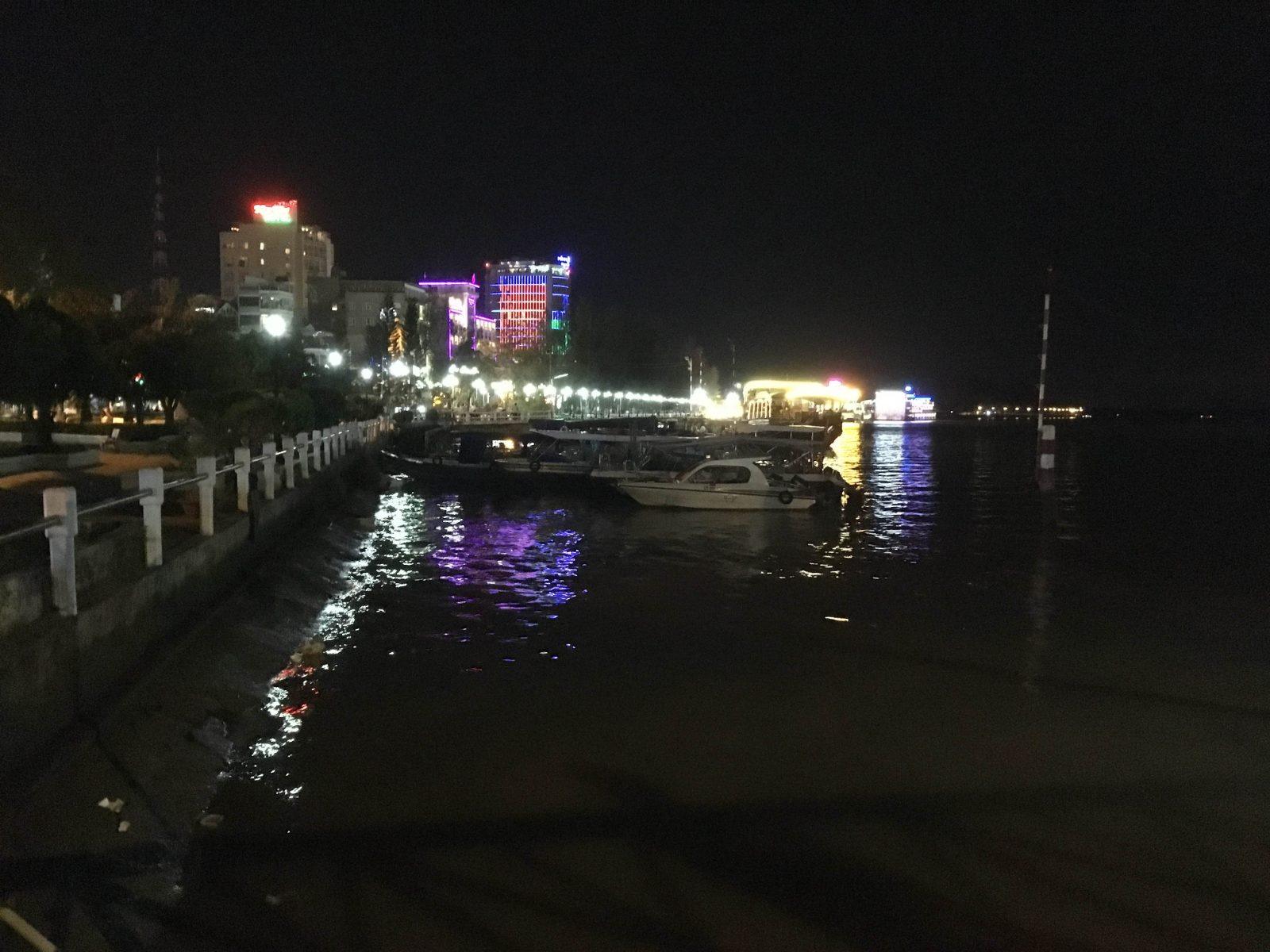 Ninh Kieu wharf and pedestrian bridge illuminated at night in Can Tho