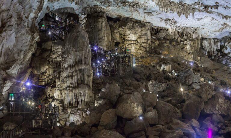 Illuminated stalactite formations and wooden walkway inside Paradise Cave, Phong Nha-Ke Bang National Park
