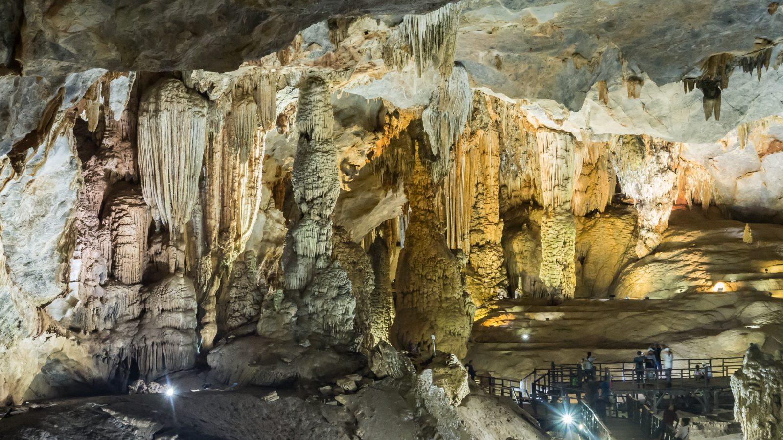 Wide chamber of stalactite and stalagmite formations inside Paradise Cave