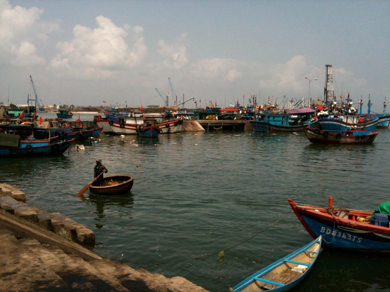 Traditional fishing boats moored at a wharf in Quy Nhon, Vietnam