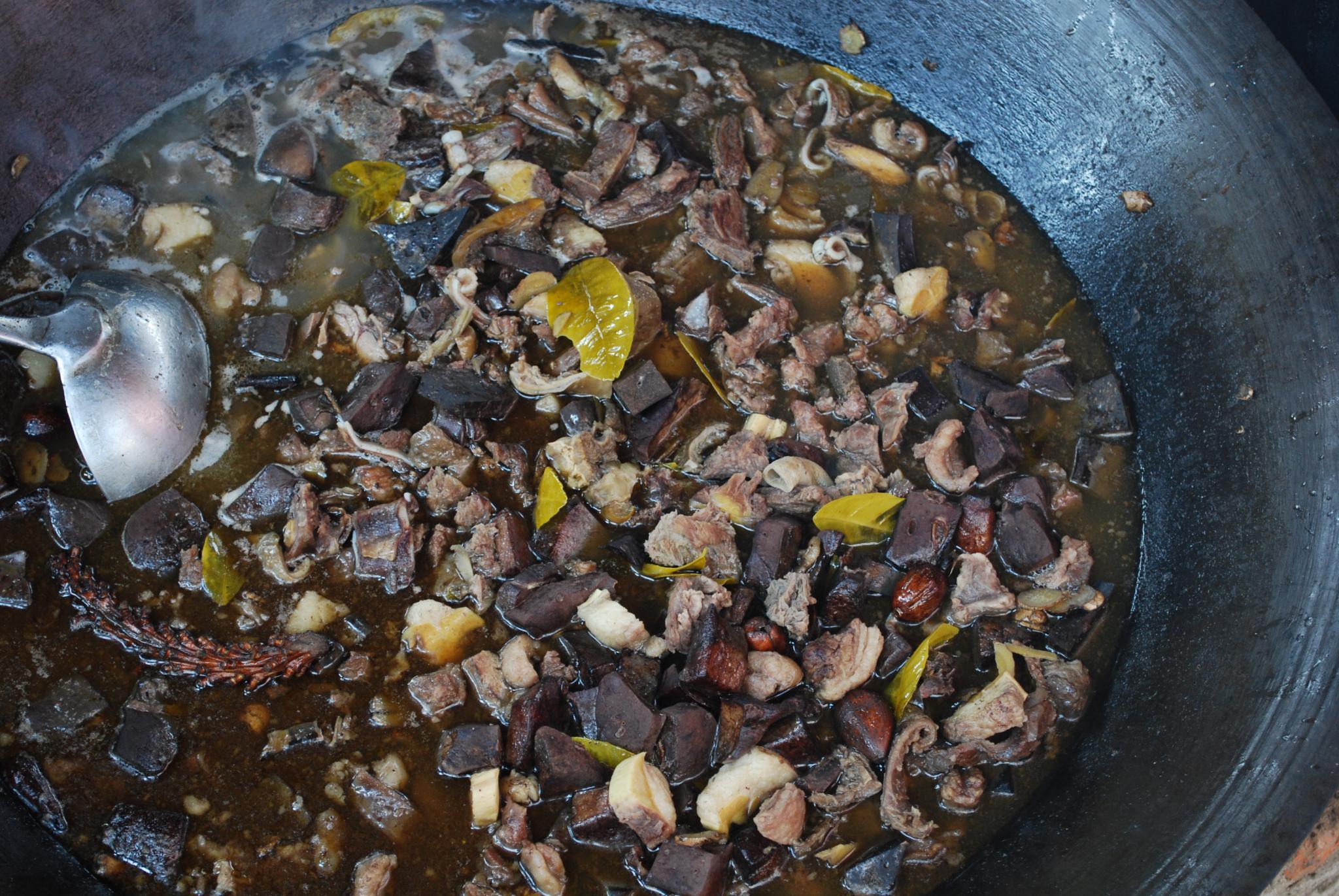 A pot of thang co, a traditional Hmong stew of buffalo or horse meat slow-cooked with mountain herbs and spices