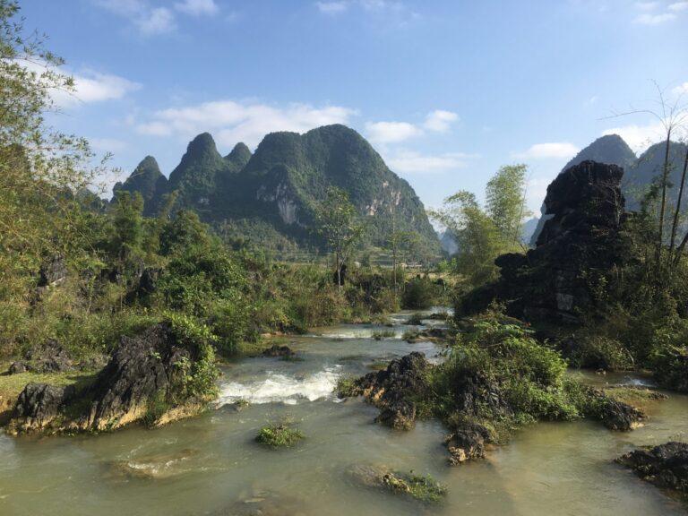 A turquoise river winding through karst mountains in Trung Khanh District near Ban Gioc